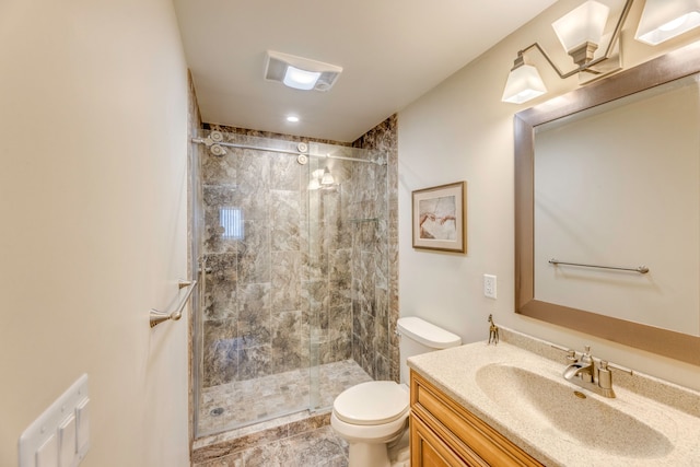 bathroom featuring vanity, toilet, and a shower with shower door