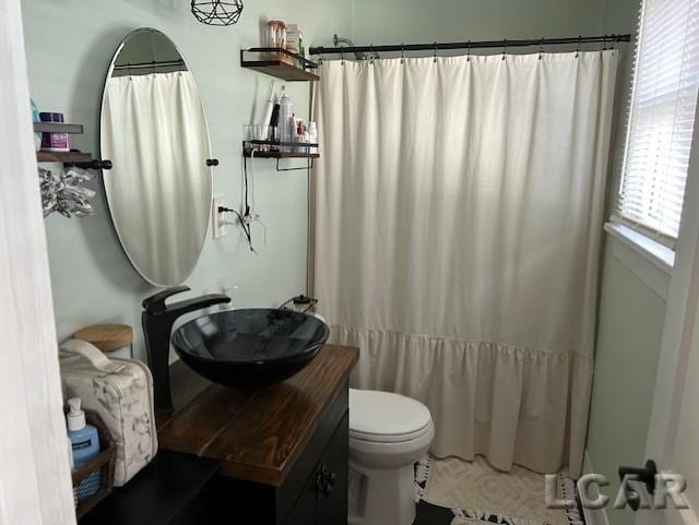 bathroom with vanity, a shower with curtain, and toilet