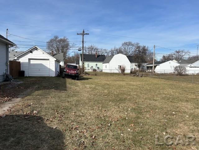 view of yard featuring an outbuilding and a garage