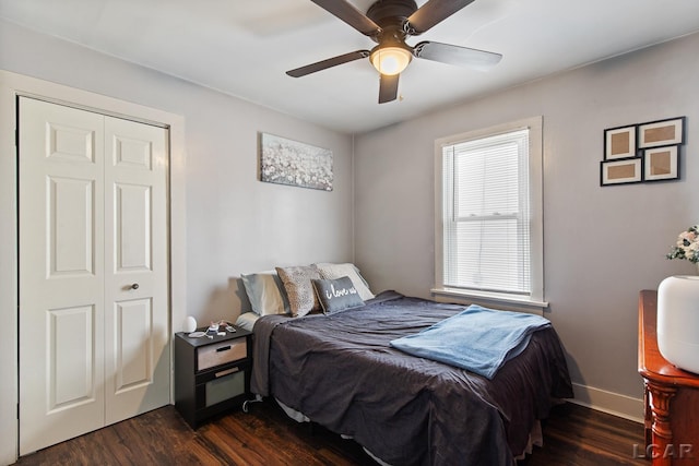 bedroom with ceiling fan, dark hardwood / wood-style floors, and a closet