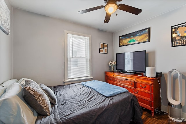 bedroom with dark wood-type flooring and ceiling fan