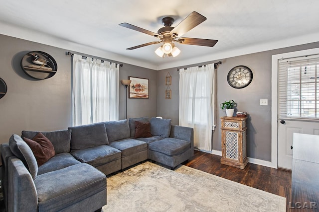 living room with dark hardwood / wood-style flooring and ceiling fan