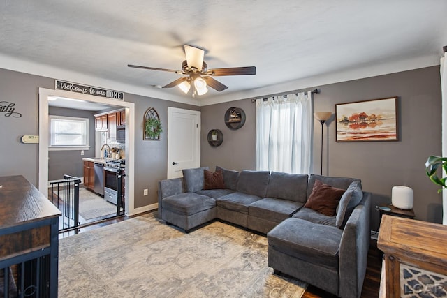 living room featuring sink and ceiling fan