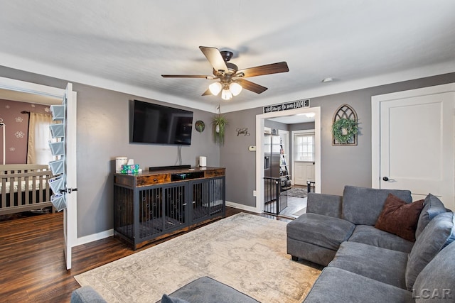 living room featuring dark hardwood / wood-style floors and ceiling fan