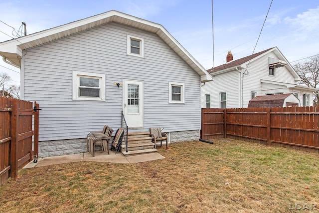 rear view of house featuring a lawn