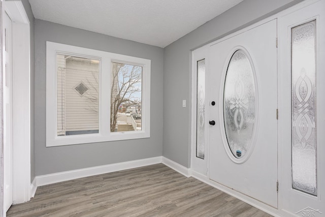 entrance foyer featuring hardwood / wood-style floors and a textured ceiling