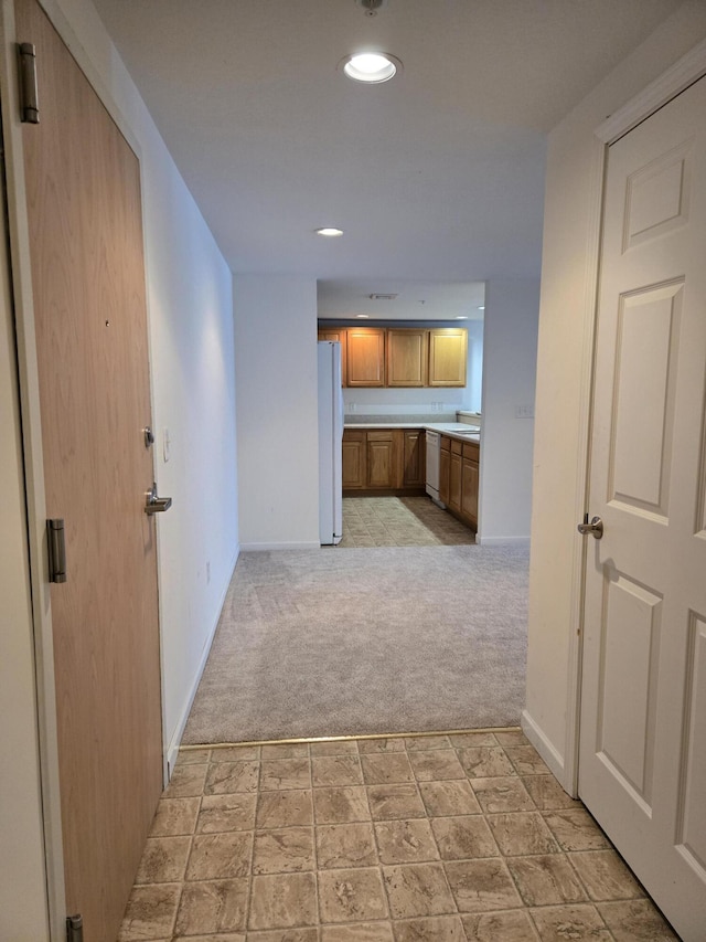 hall featuring light colored carpet