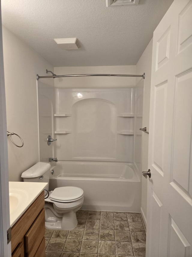 full bathroom with shower / tub combination, vanity, toilet, and a textured ceiling