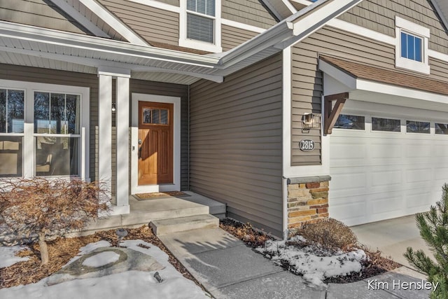 view of exterior entry with a garage