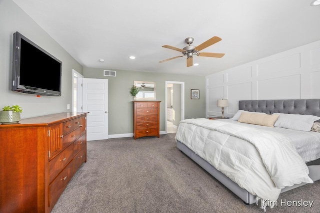 carpeted bedroom with ceiling fan and ensuite bath