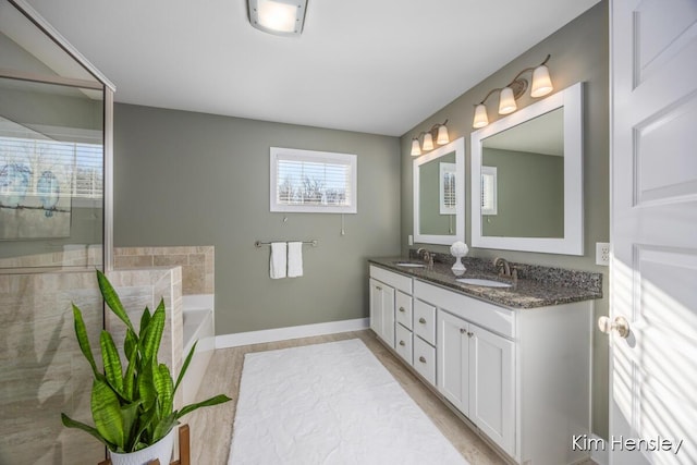 bathroom featuring vanity and a tub to relax in