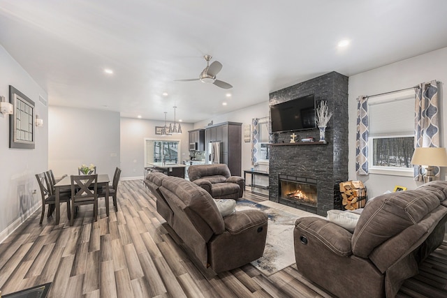 living room with hardwood / wood-style flooring, a fireplace, and ceiling fan