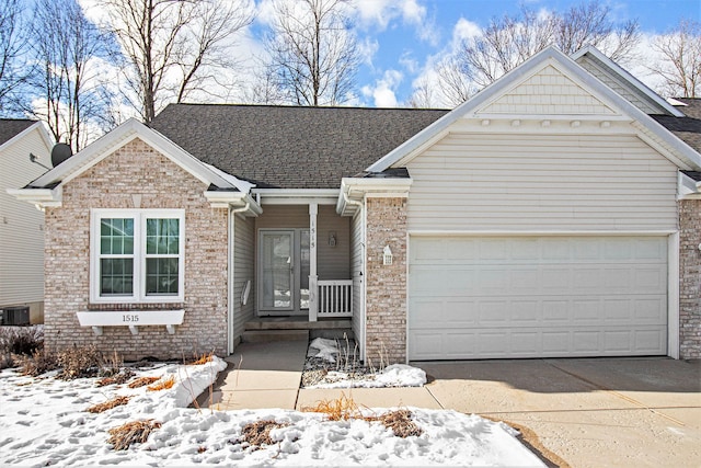 view of front of property featuring a garage and central AC unit