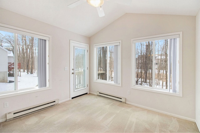 empty room featuring baseboard heating, light colored carpet, lofted ceiling, and a healthy amount of sunlight