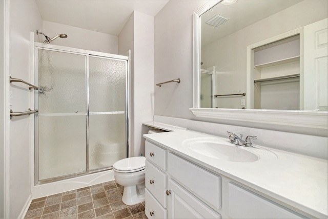 bathroom with vanity, toilet, and an enclosed shower