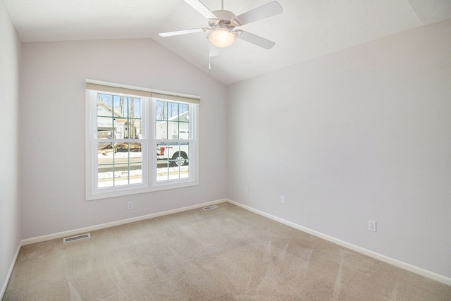 empty room featuring ceiling fan, lofted ceiling, and carpet floors