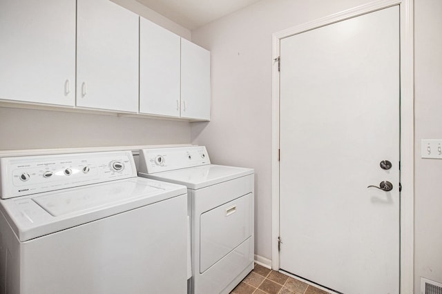 laundry room featuring cabinets and washing machine and dryer