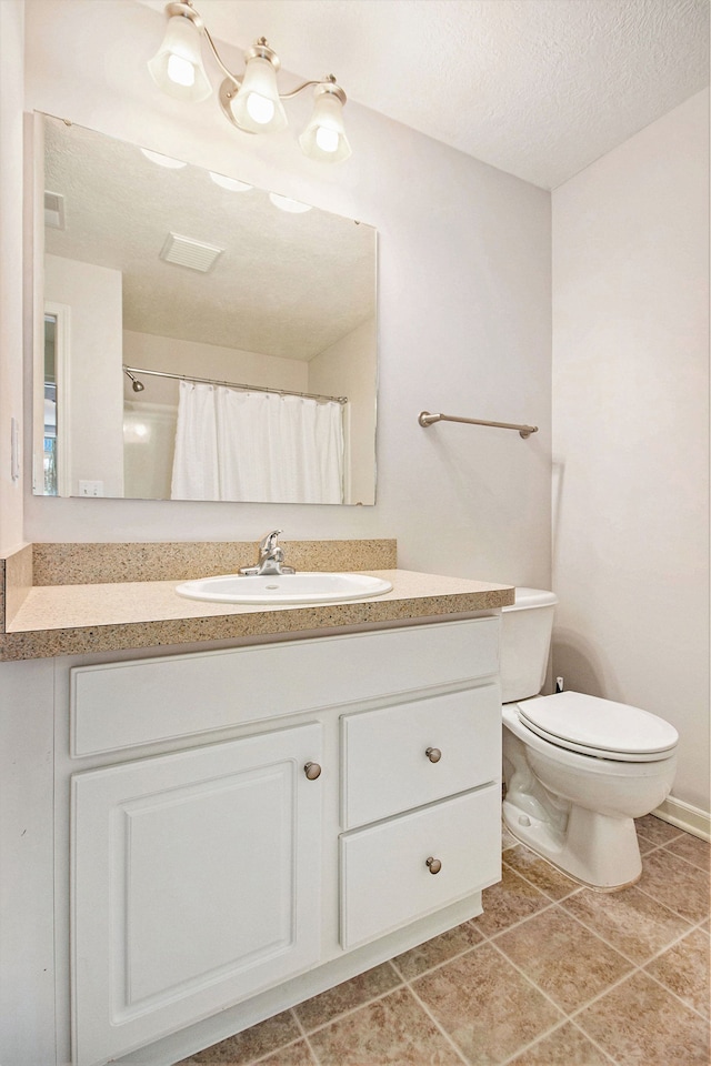 bathroom with tile patterned flooring, a shower with shower curtain, vanity, a textured ceiling, and toilet