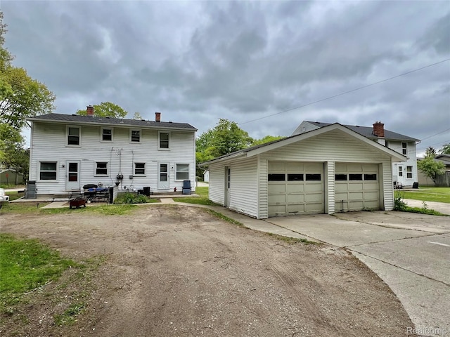 2855 20th Ave, Port Huron, MI 48060 - rear view of property featuring an outbuilding, a detached garage, and a chimney