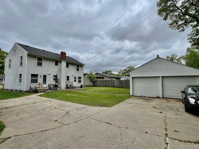 2855 20th Ave, Port Huron, MI 48060 - back of house with a chimney, an outbuilding, and a garage