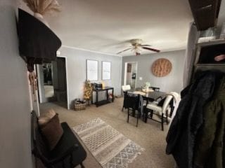 living room featuring light colored carpet and ceiling fan