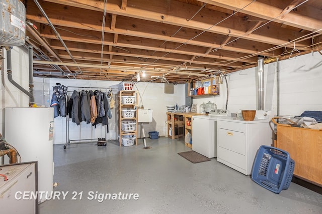 basement with water heater and washer and dryer