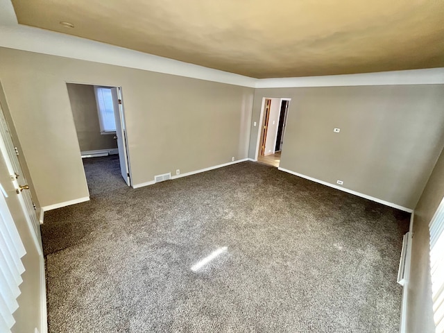 carpeted empty room with a baseboard radiator