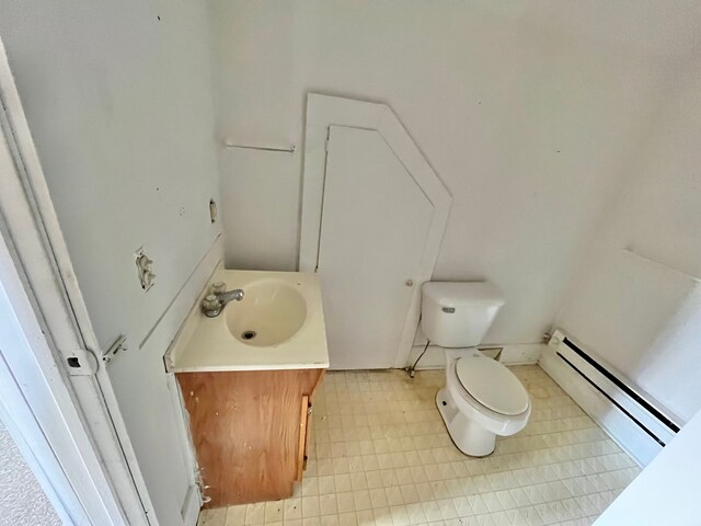 bathroom with a baseboard radiator, vanity, and toilet