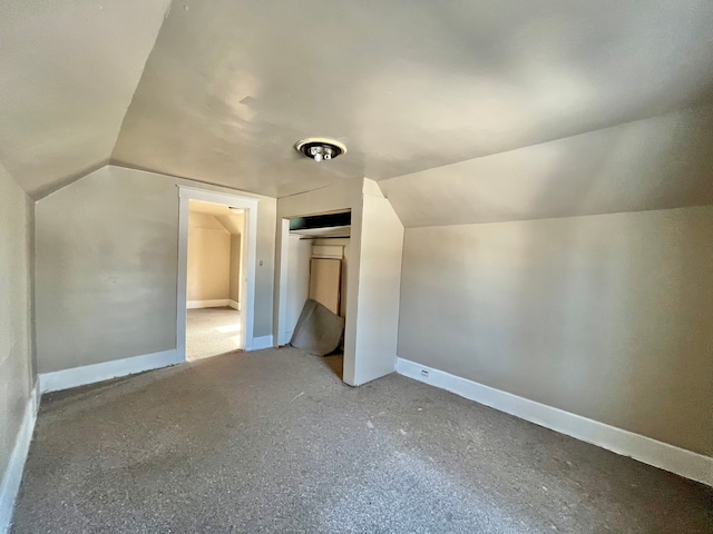 additional living space featuring lofted ceiling