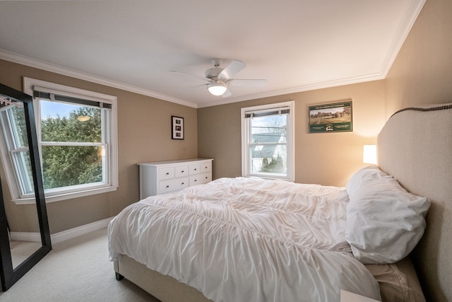 bedroom featuring light carpet, crown molding, and ceiling fan