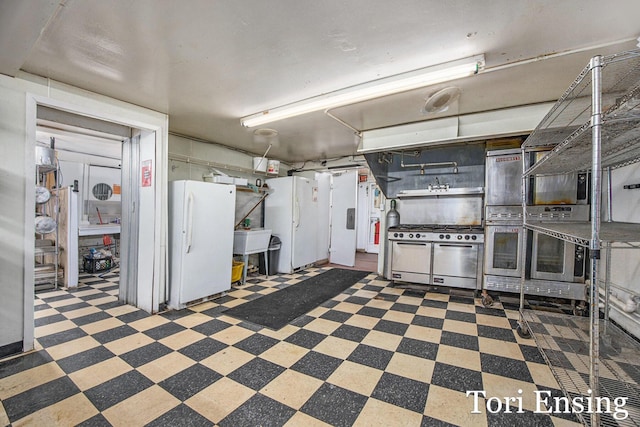 basement featuring white fridge