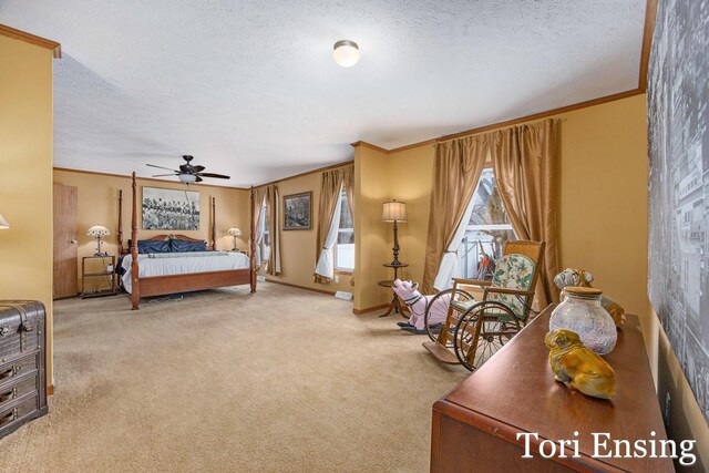 bedroom featuring ceiling fan, crown molding, carpet floors, and a textured ceiling