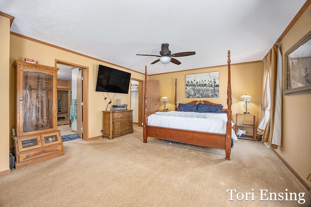 carpeted bedroom featuring ornamental molding, ceiling fan, and ensuite bathroom