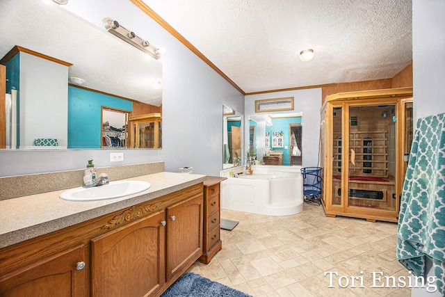 bathroom with crown molding, vanity, and a textured ceiling