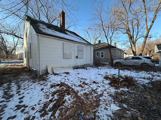 view of snow covered rear of property