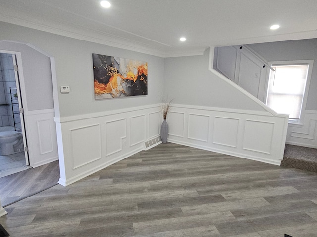 spare room with dark hardwood / wood-style flooring and ornamental molding