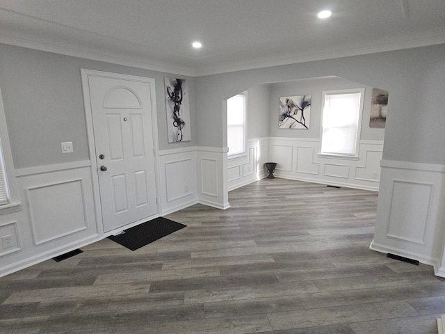 foyer entrance with crown molding and wood-type flooring