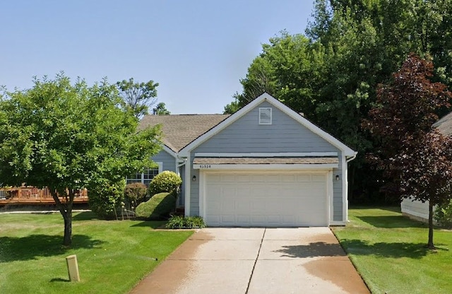 view of front of home featuring a garage, concrete driveway, and a front lawn