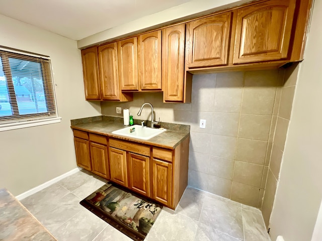 kitchen with sink and light tile patterned flooring