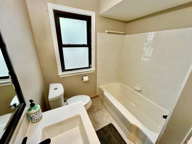 bathroom with toilet and tile patterned flooring