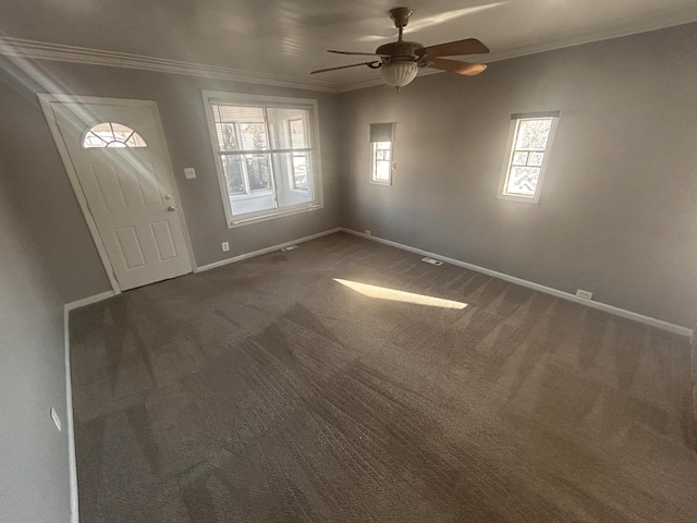 carpeted entrance foyer featuring crown molding and ceiling fan