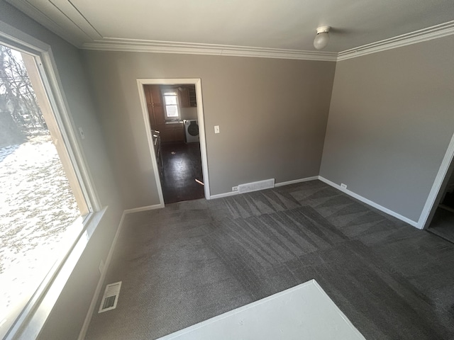 empty room with crown molding and dark carpet