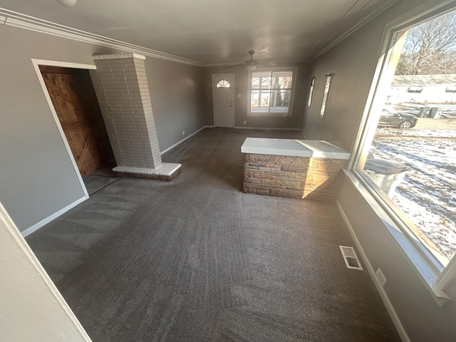 carpeted spare room featuring crown molding and ceiling fan