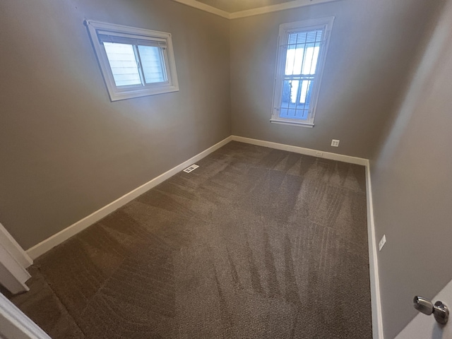 empty room featuring a healthy amount of sunlight and carpet flooring