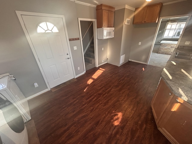 interior space featuring dark wood-type flooring and dark stone counters