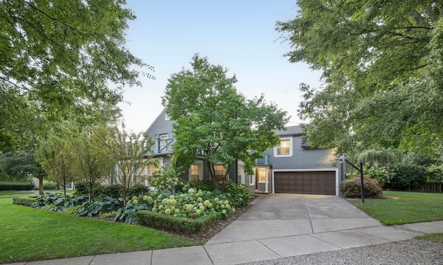 view of front of home featuring a garage and a front yard