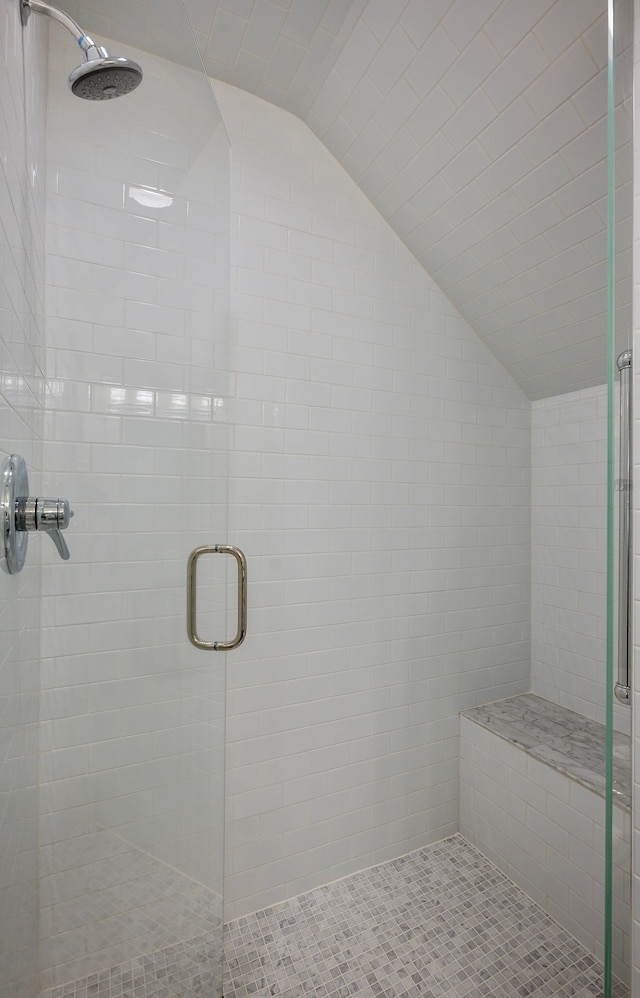 bathroom with an enclosed shower and vaulted ceiling