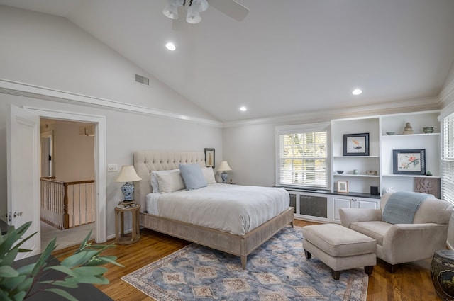 bedroom featuring hardwood / wood-style flooring, ornamental molding, and high vaulted ceiling