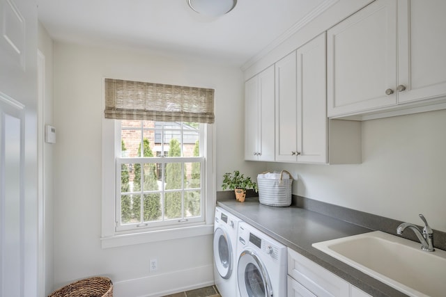 laundry area with washer and dryer, sink, and cabinets