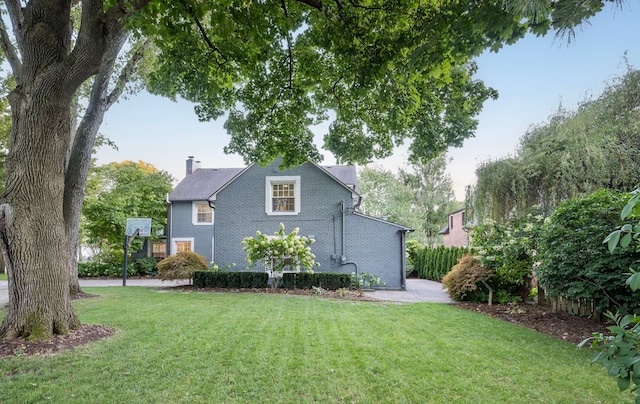 view of property exterior featuring a lawn